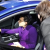 Pritzker sits at the wheel of a new car