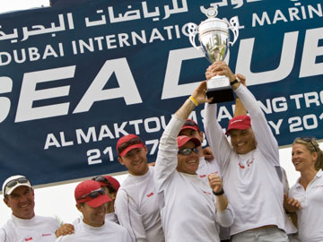 Torbjorn Tornqvist and Terry Hutchinson raise the winner's trophy at the Al Maktoum Sailing Trophy RC44 2010 