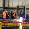 Secretary Penny Pritzker (center) observes an advanced plasma cutter at work