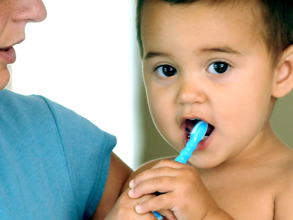 toddler brushing with blue toothbrush