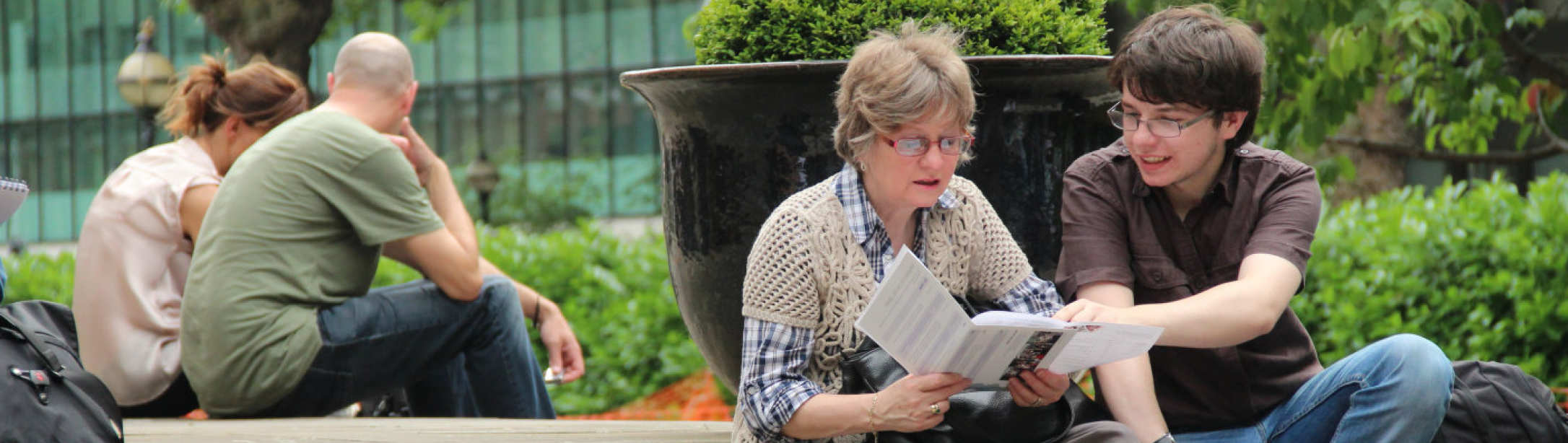 Parent and son looking at prospectus