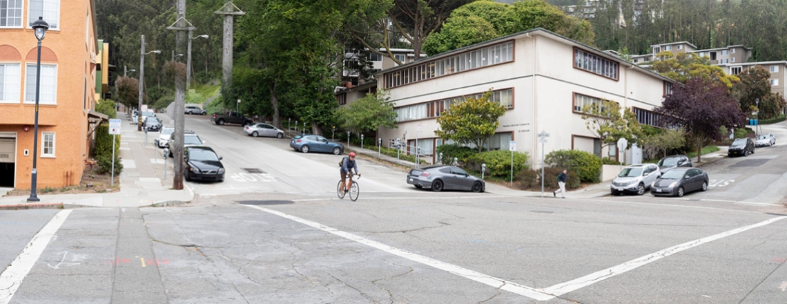 a bicyclist rides through the intersection at Fifth Avenue and Kirkham