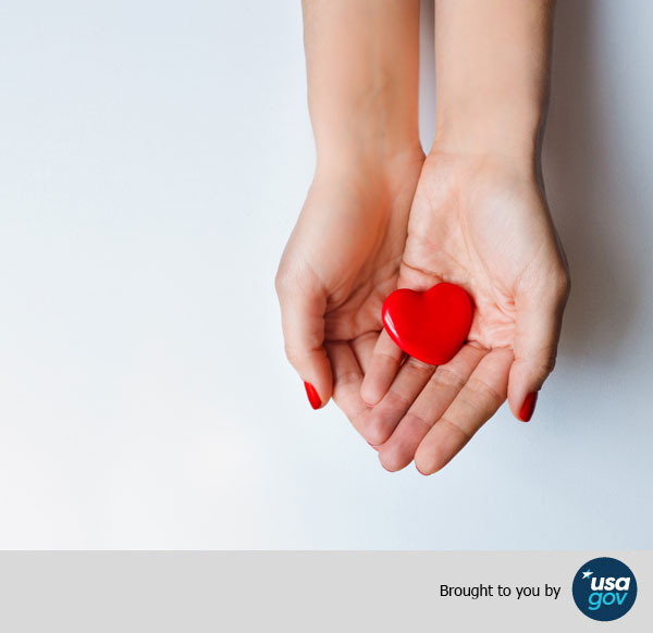 Red heart holding in female hands, Brought to you by USAGov.