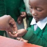 Child receiving medicine.