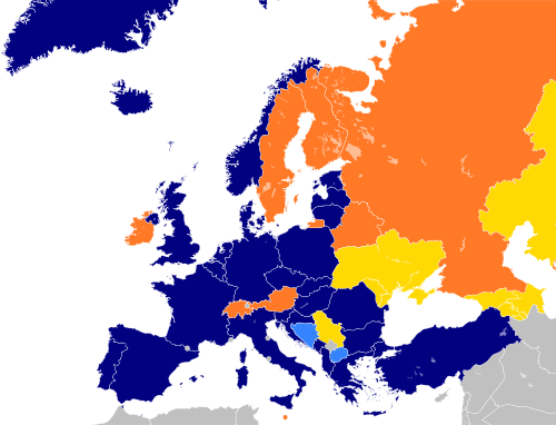 A map of Europe with countries in blue, cyan, orange, and yellow based on their NATO affiliation.