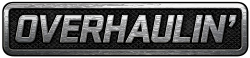 A simple logo spelling the word "Overhaulin'" in silver over what appears to be a car grill or interlaced gray mesh