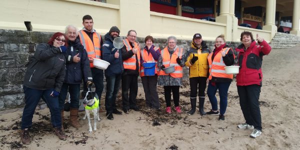 Challenge Wales volunteers on Barry Island beach doing a microplastics survey