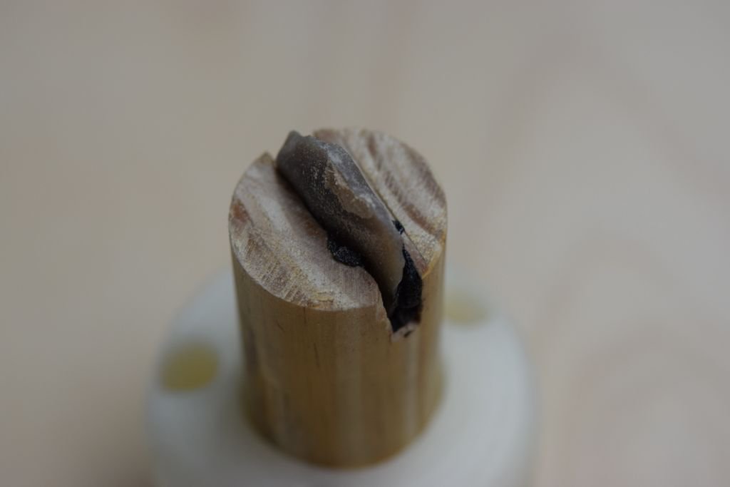 Researchers used birch pitch to attach flint to wood, as Neanderthals would have done, but the wood was fashioned into a type of drill bit so their force-controlled robotic arm could precisely test the adhesion. Image credit: NYU Tandon, Johannes Pfleging