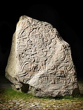 Large stone containing a carved depiction of Jesus Christ