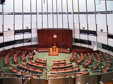 Large, round room with desks and a dais