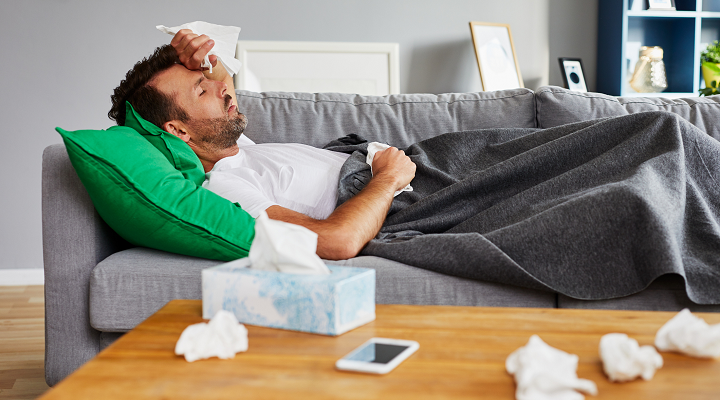 man lying on couch sick