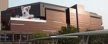 Remodeled bronze exterior in October 2018. White dog with red target around eye above signage that says Target Center