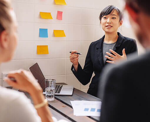 Woman presenting at a group meeting.