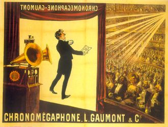 Illustration of a theater from the rear Right of the stage. At the front of the stage a screen hangs do orming. In the foreground is a gramophone with two horns. In the background, a large audience is seated at orchestra level and on several balconies. The words "Chronomégaphone" and "Gaumont" appear at both the bottom of the illustration and, in reverse, at the top of the projection screen.