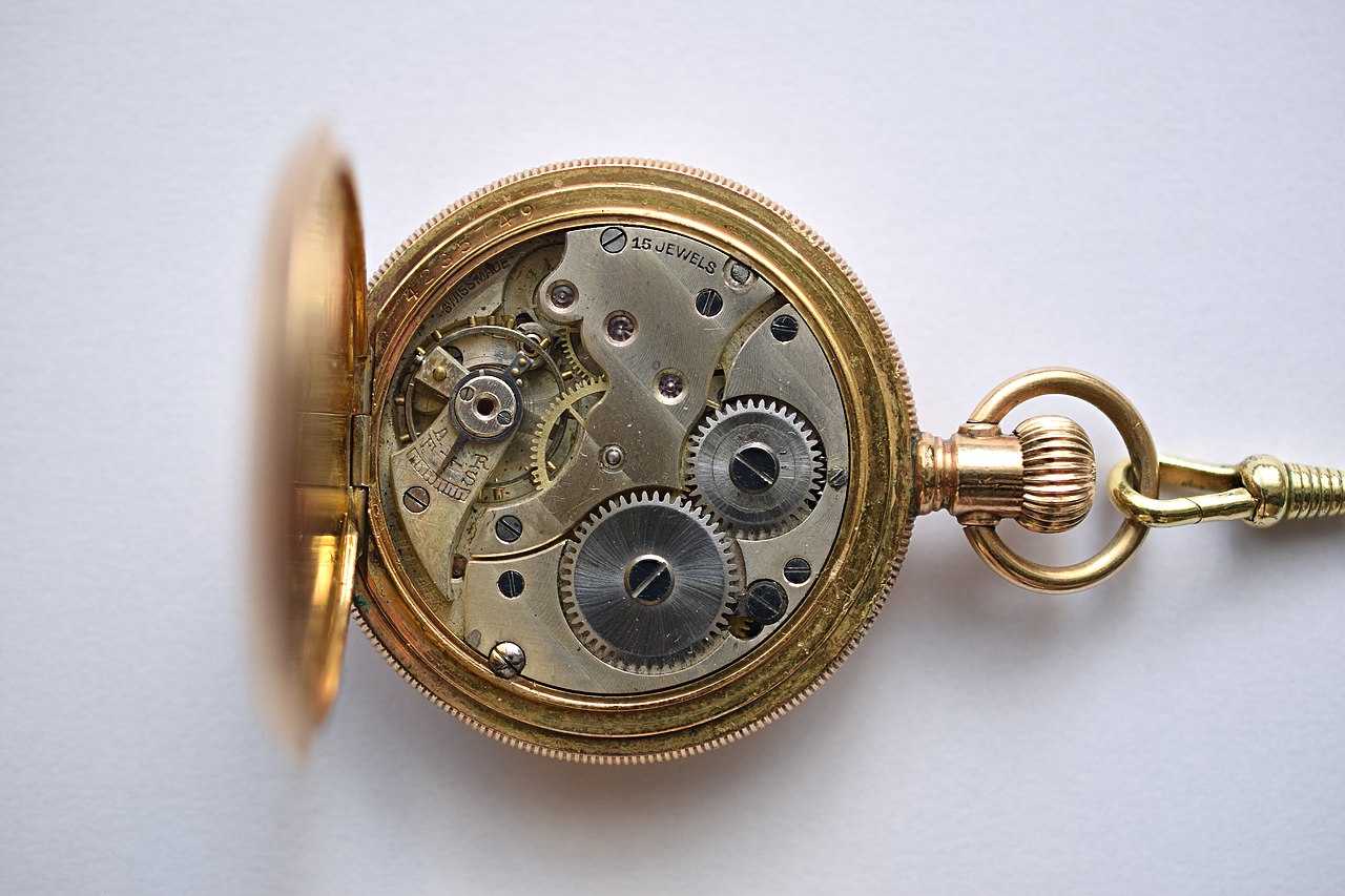 Photograph of the interior of a pocket watch showing intricate gears and fine craftsmanship.