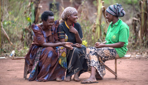 Three women communicate using sign language.