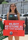 A protester holding a placard against the Keystone Pipeline at the People's Climate March 2017