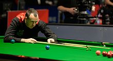 Mark Williams holding a cue