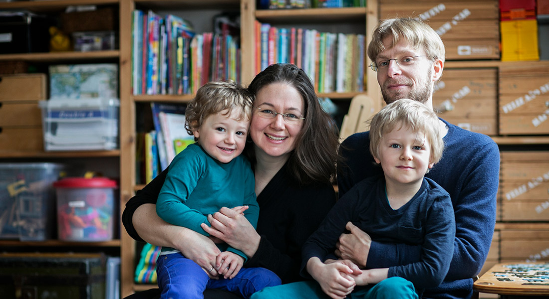 Family of four sitting on a couch