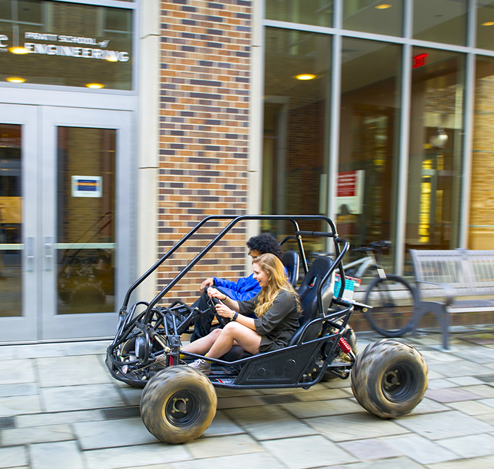 two students racing in a self-built motor car