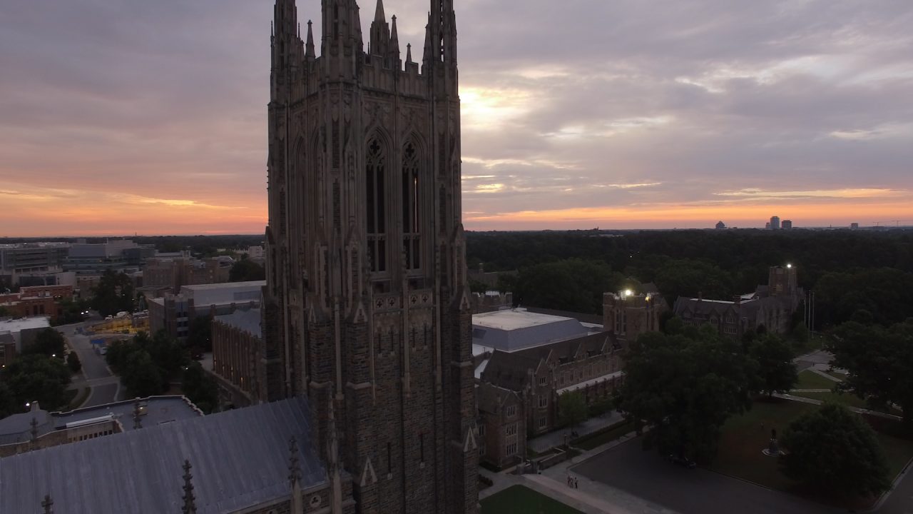 Aerial still of the sun rising over Duke Chapel