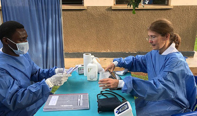 Rosalind Carter, right, and a Ugandan colleague prepare to give the Ebola vaccine to health workers