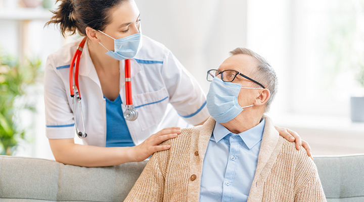 Doctor and senior man wearing facemasks