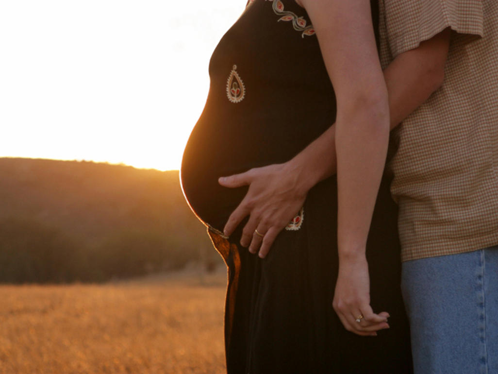 Pregnant couple watching the sunset