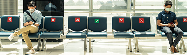 Image of people waiting at the airport wearing masks