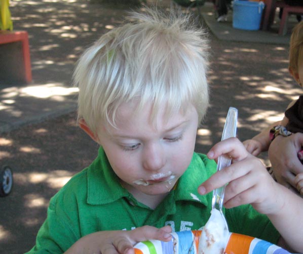 Photo of young boy eating ice cream