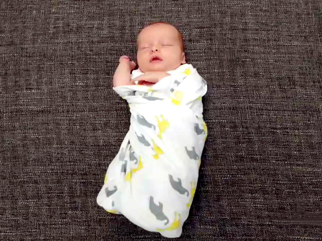 Baby sleeping swaddled in a blanket