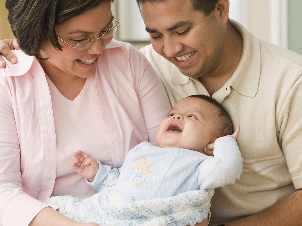 Parents looking over smiling baby