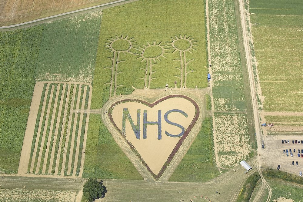 Hayling Island 

A large heart with ‘NHS’ carved in its centre and sunflowers sprouting from above can be seen inscribed into a maze field on Hayling Island, just off the south coast of England.

Hayling Island 33889_054
© Historic England Archive