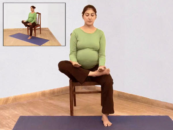 Pregnant woman in the modified pigeon yoga pose