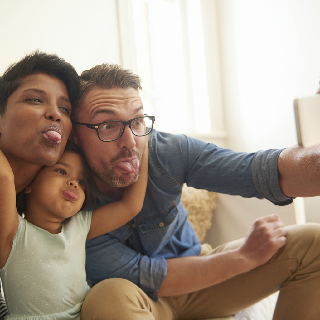 happy family sticking the tongues out and taking a selfie