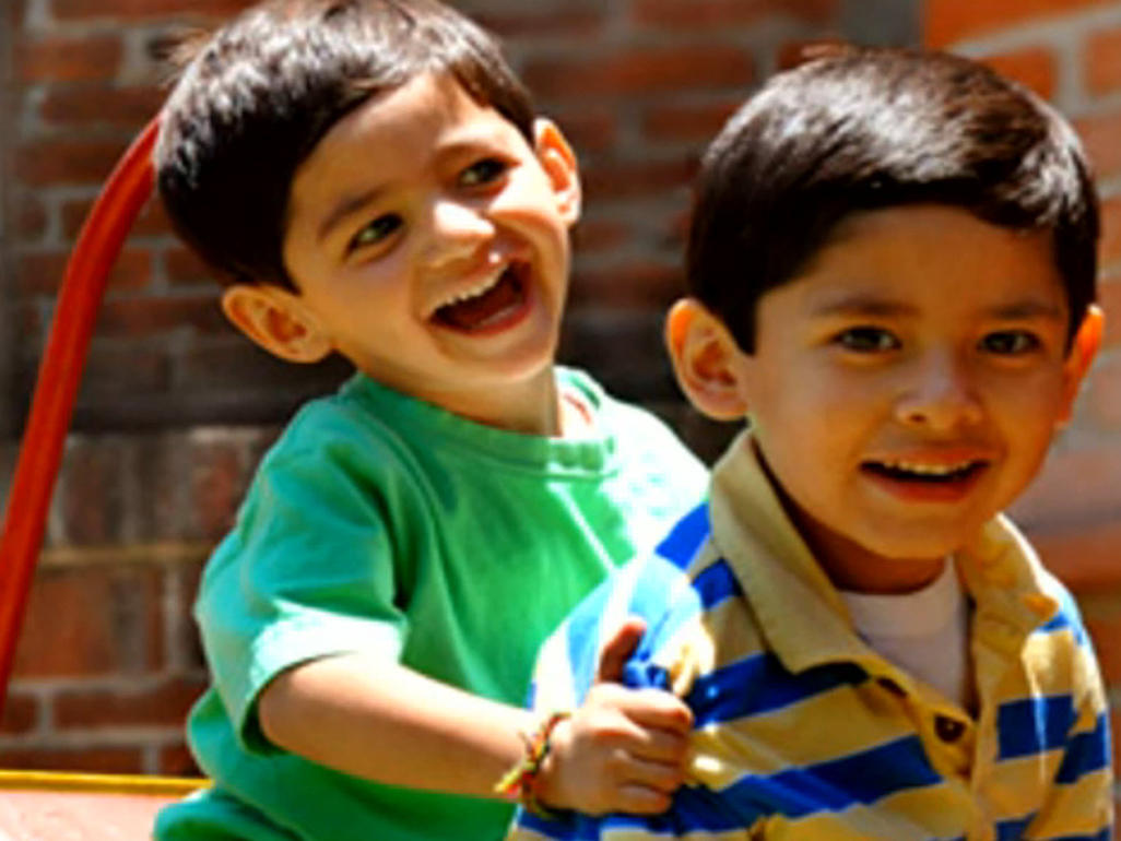 two boys in sunshine smiling