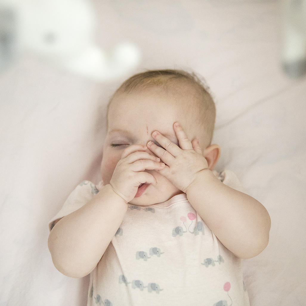 A baby sleeps in a crib