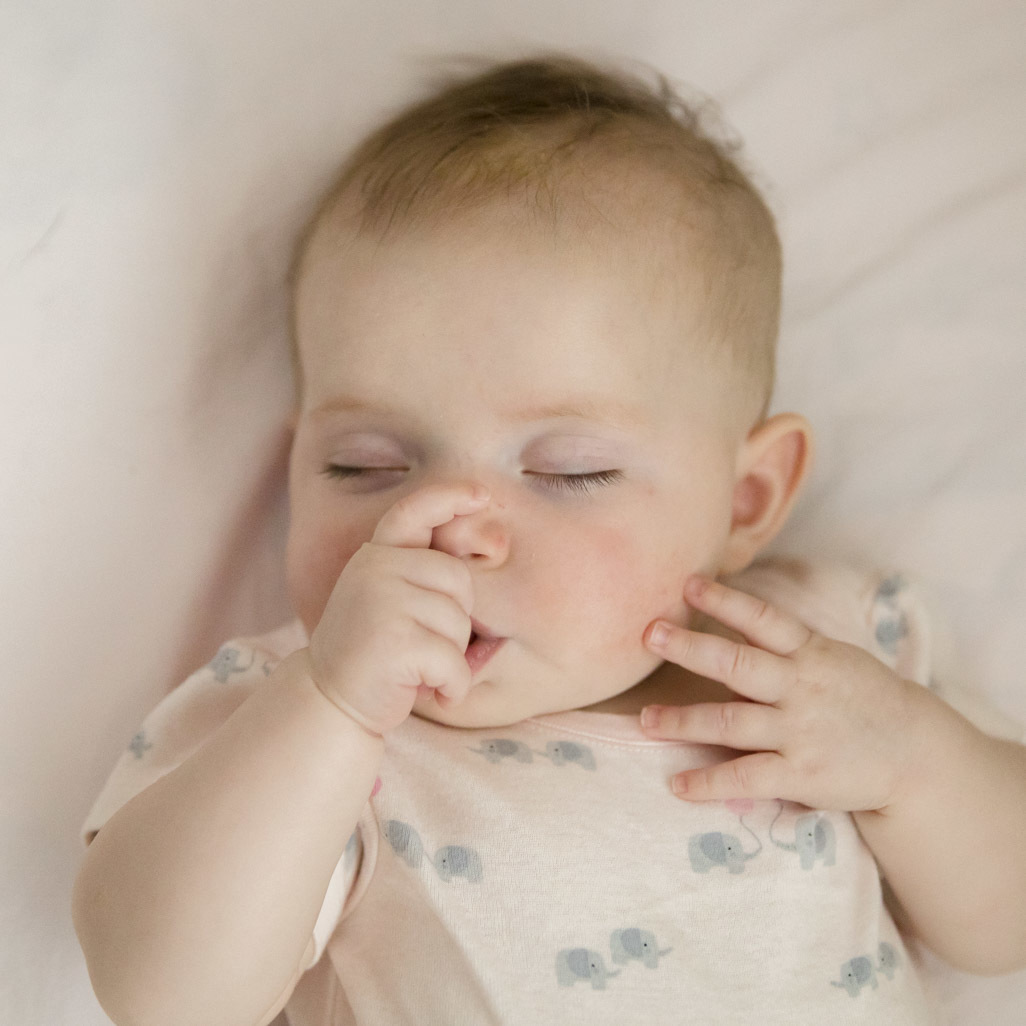 Baby sucking her finger while sleeping