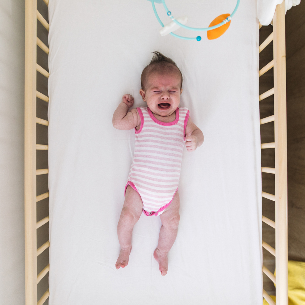 Baby crying in a crib