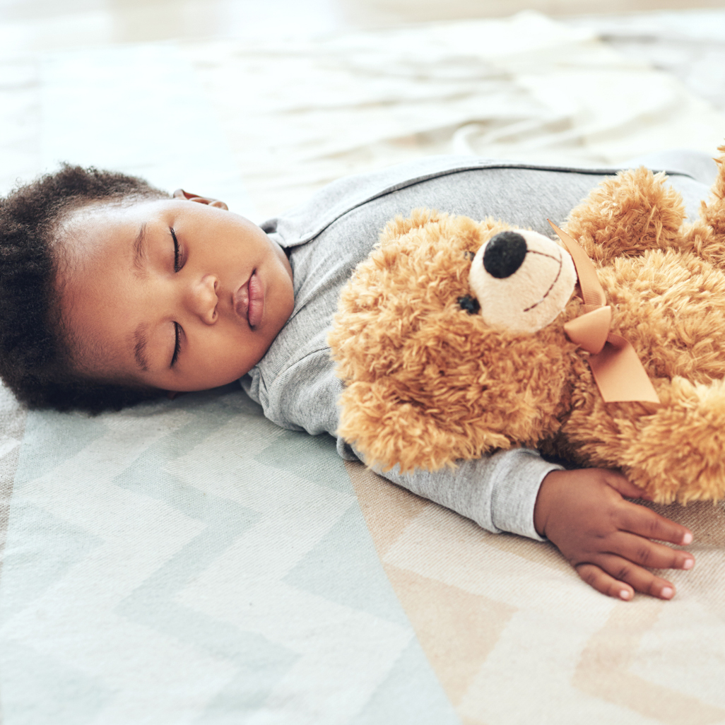 Baby sleeping holding a teddy bear