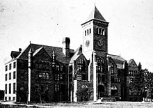 Early 20th-century black-and-white photo of three-story building