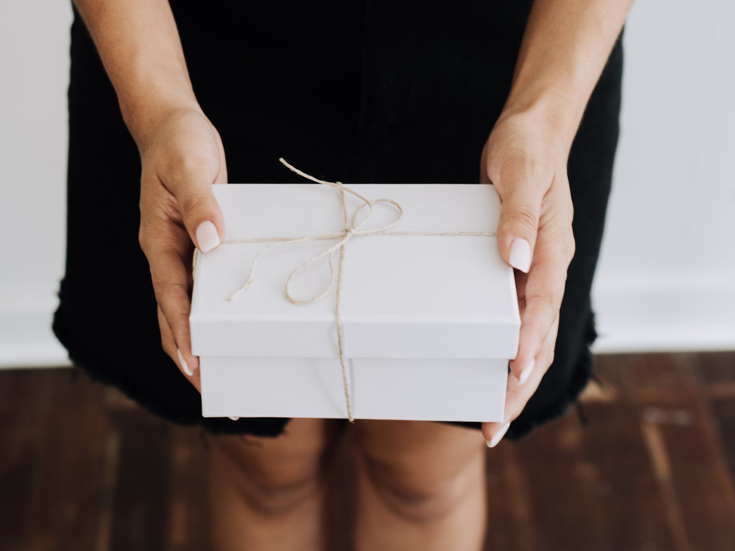 Canva+-+Woman+Holding+a+Wrapped+Gift.jpg