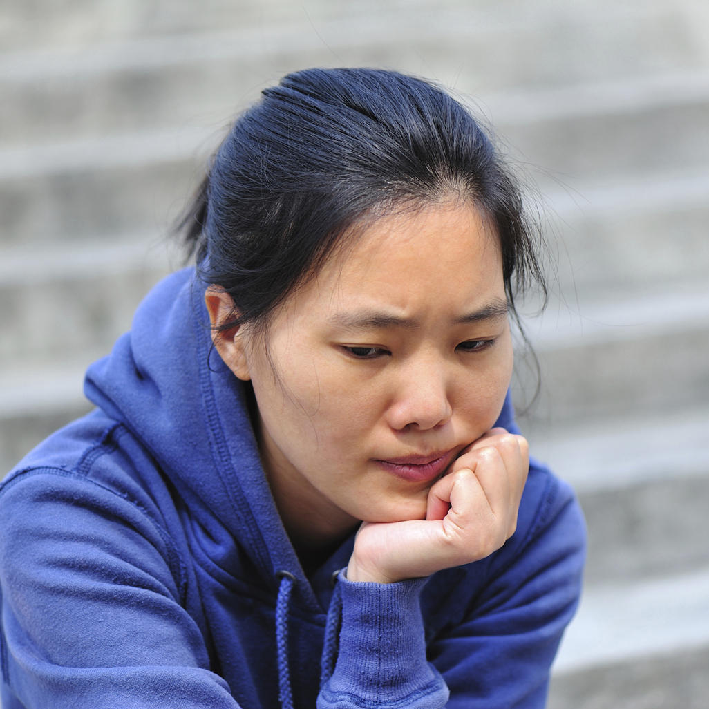 worried woman sitting on stairs