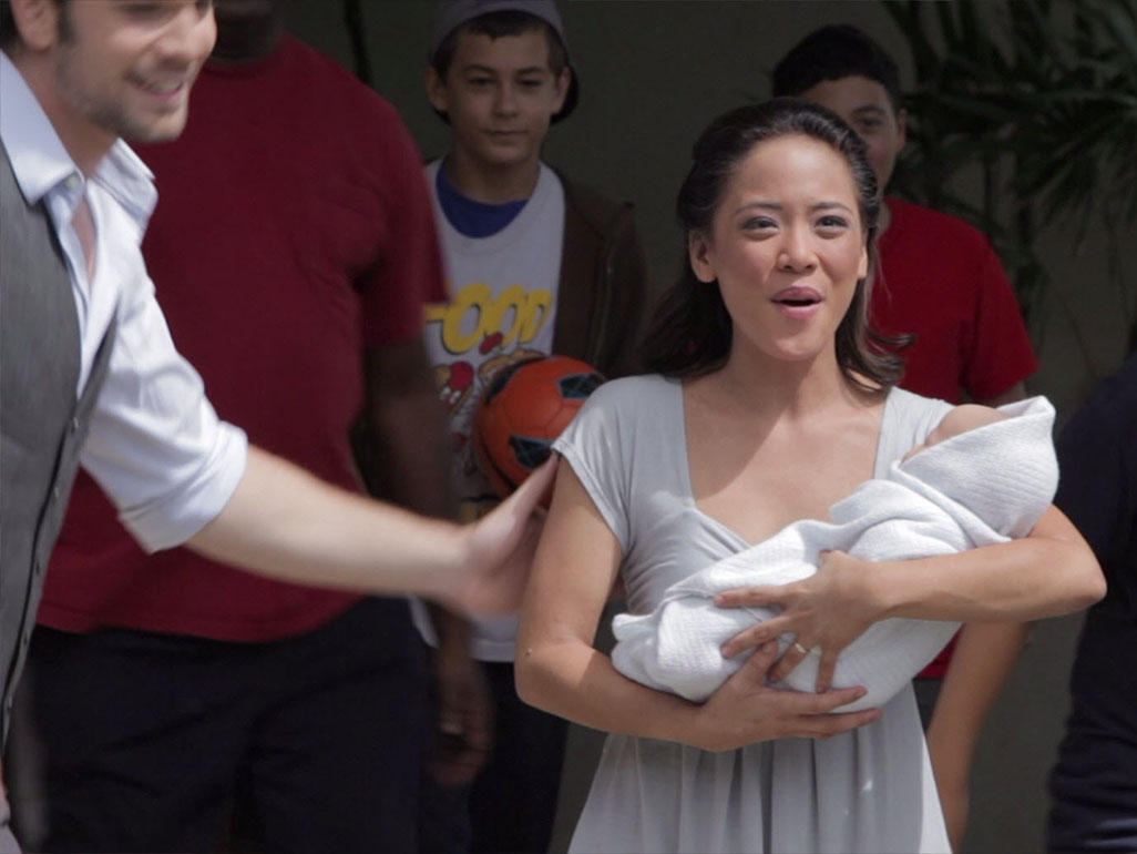 woman holding baby and singing