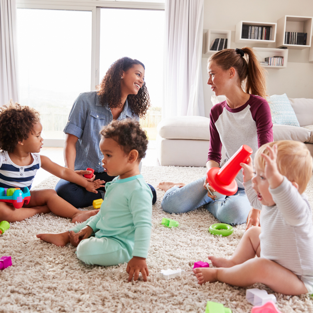 group of moms and babies playing on the floor