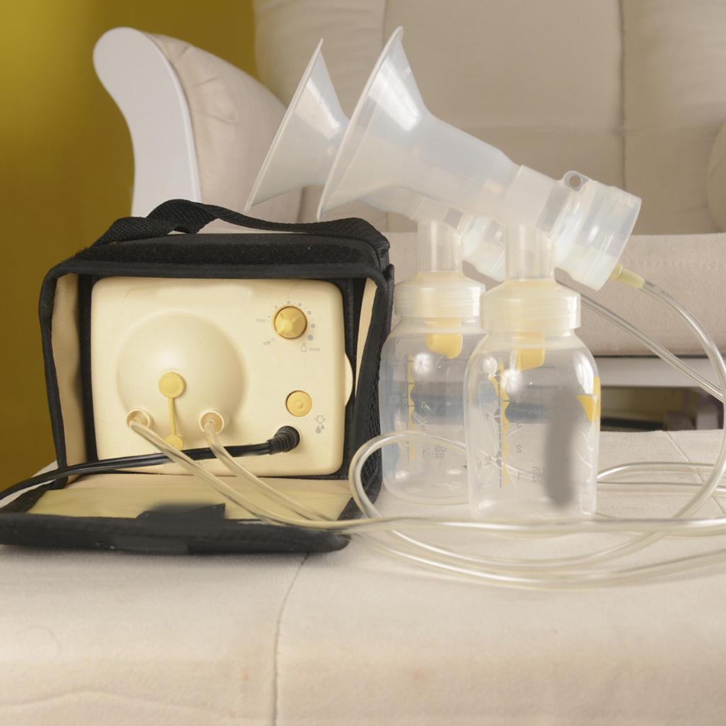 square breastpump with two bottles, tubes, and suction pump