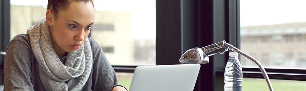 A young woman working on a laptop