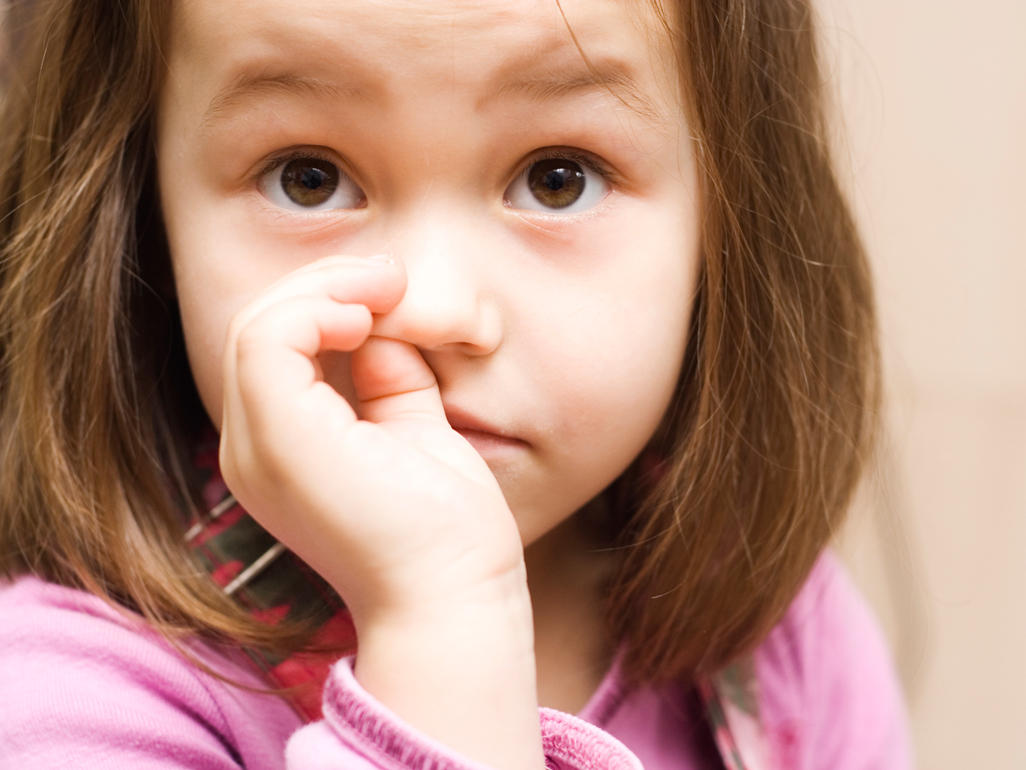 preschool-aged girl picking her nose