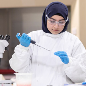 Virtual Open Week banner - a woman wearing a white coat in a lab