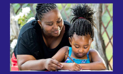 Black woman and girl writing together